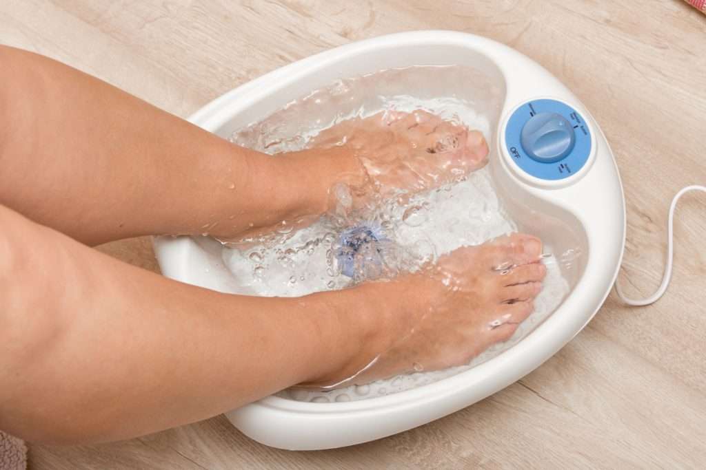 A photo of feet soaked in a foot spa device