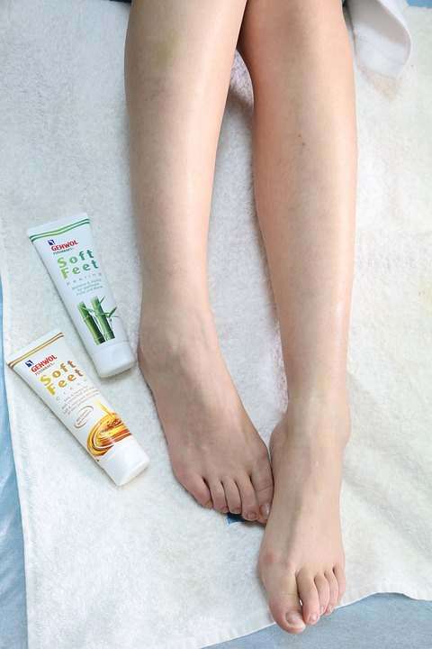 A Photo of A Woman’s Feet and Foot Care Cream