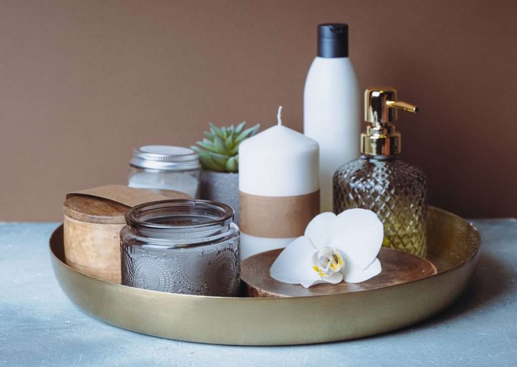 A photo of a foot and hand cream on a golden tray