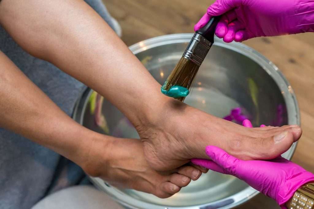 A photo of a person holding brush and foot