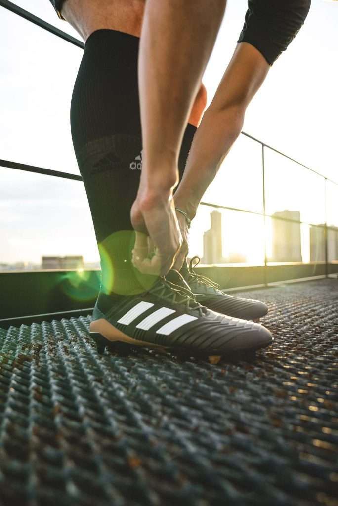 A photo of a person wearing black compression socks