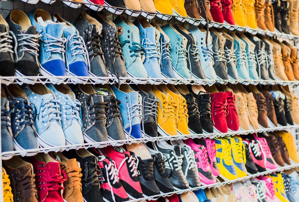 Many pairs of sneakers on a shelf
