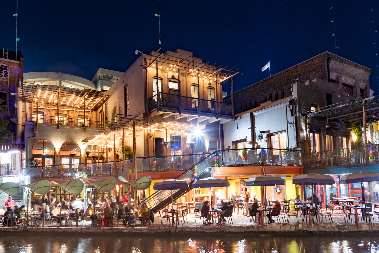 people enjoy the evening at the San Antonio River Walk