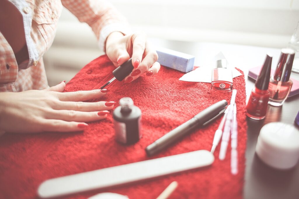 a woman polishing her own nails